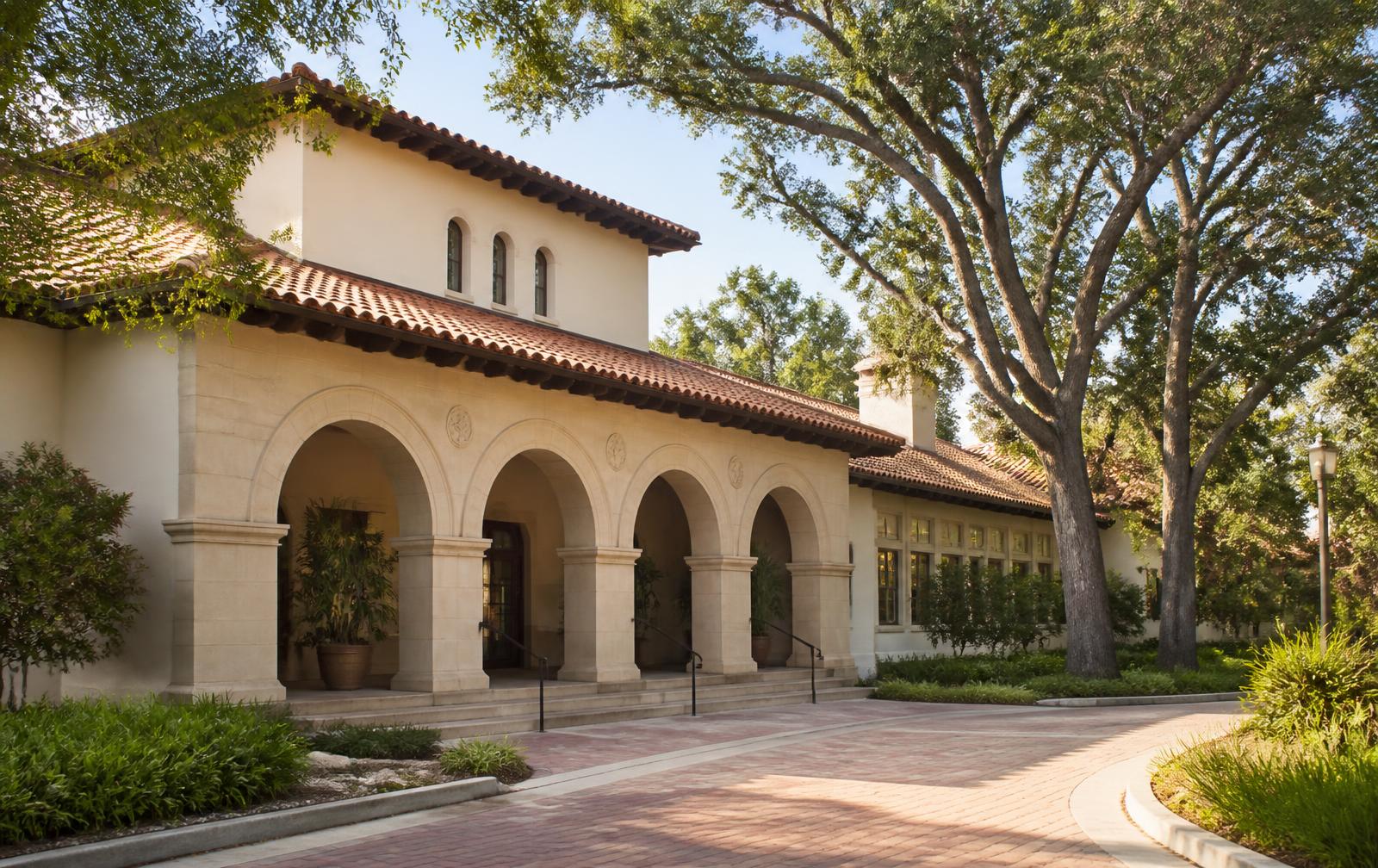 Arched sandstone entrance and brick arrival path of the Stanford Faculty Club